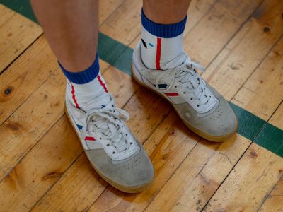 Close up of sneakers on a wooden floor during movement.