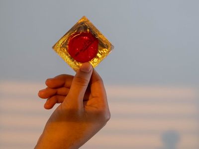 Shadow of a person stretching against a white wall.